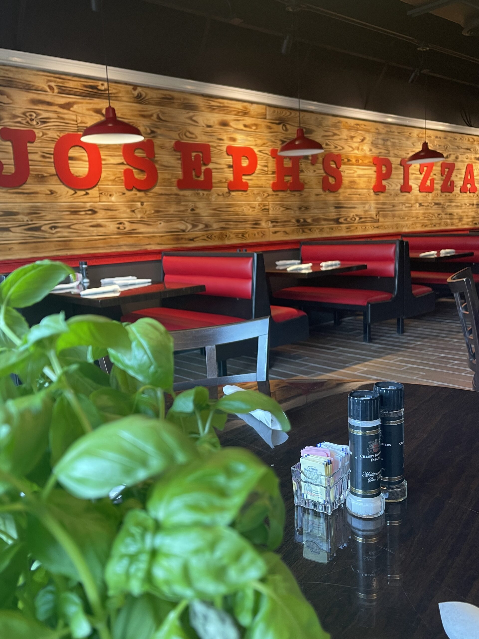 A restaurant with a large wooden sign on the wall
