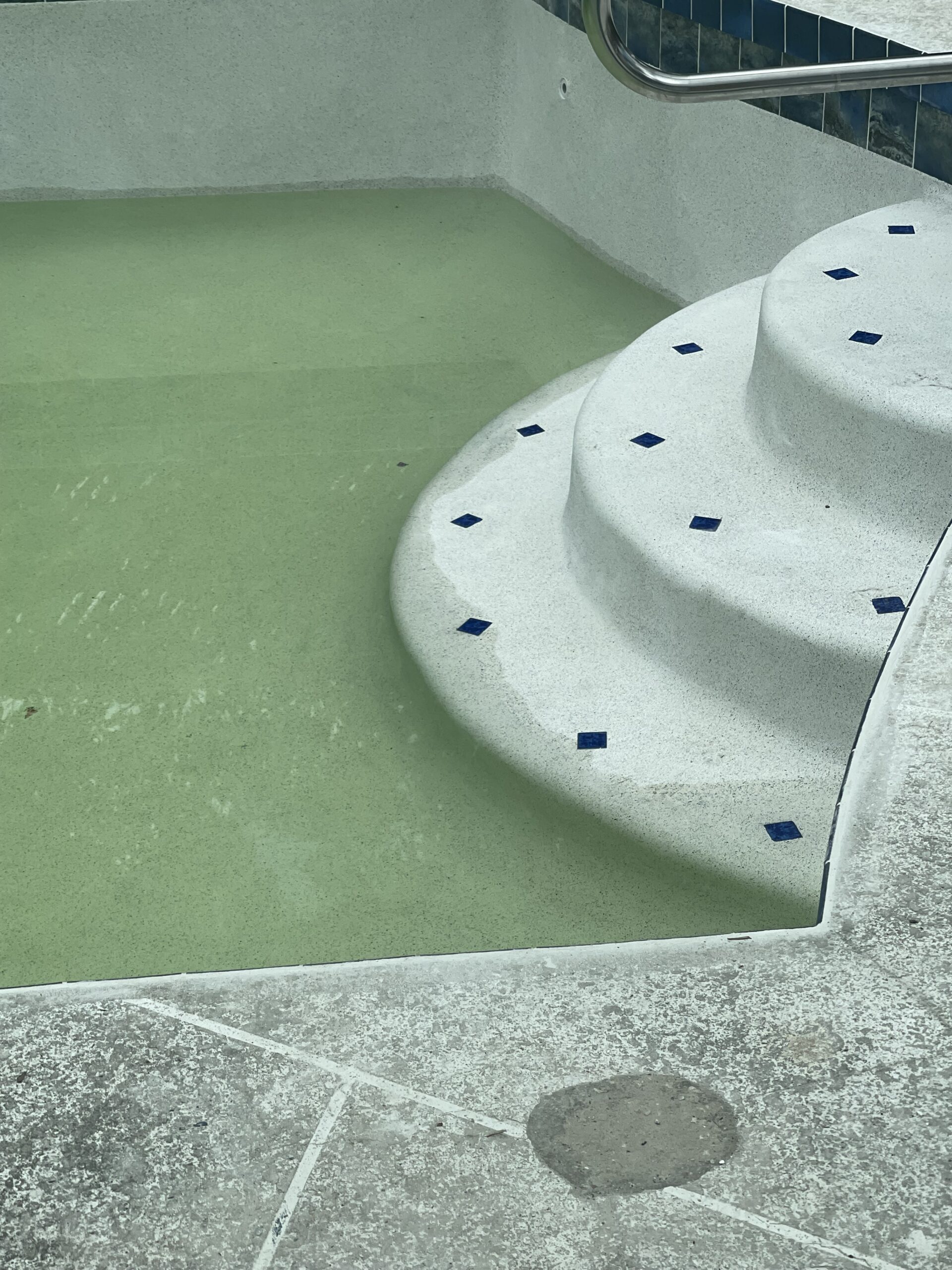 A pool of water with steps leading up to it
