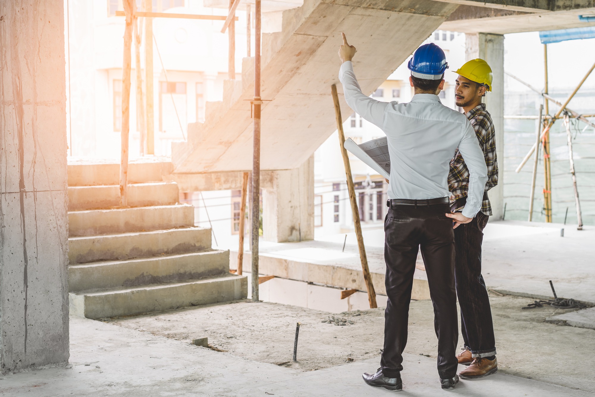 Asian contractor and engineer inspecting material in construction building