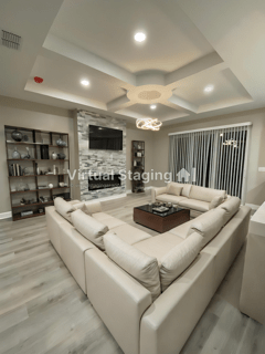 A living room with a large couch and a flat screen tv