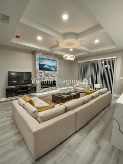 A living room with a large couch and a flat screen tv