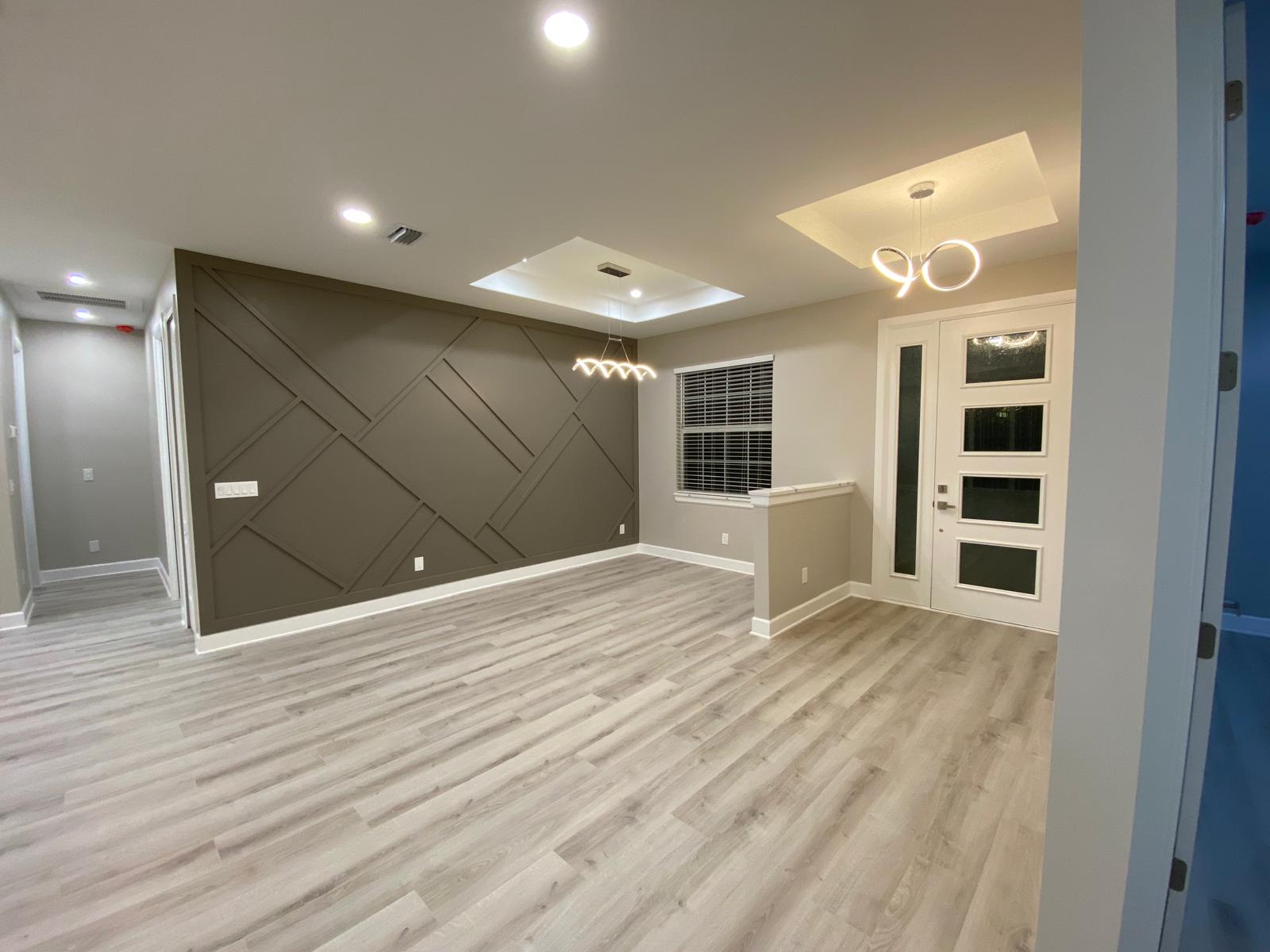 An empty room with a wood floor and white walls