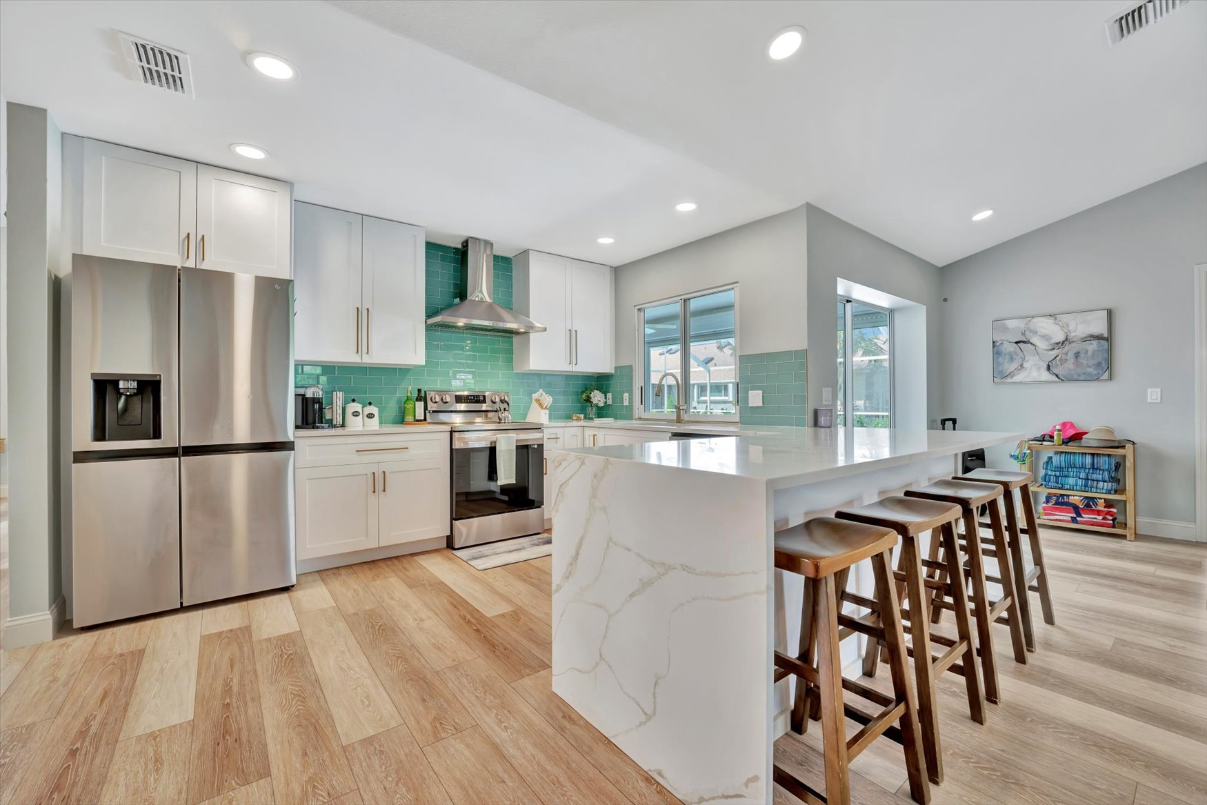 Completed open-concept home remodeling with kitchen and living area in Southwest Florida