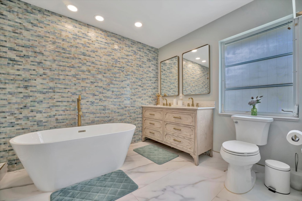 Remodeled bathroom with freestanding tub, walk-in shower, and vanity in Southwest Florida home