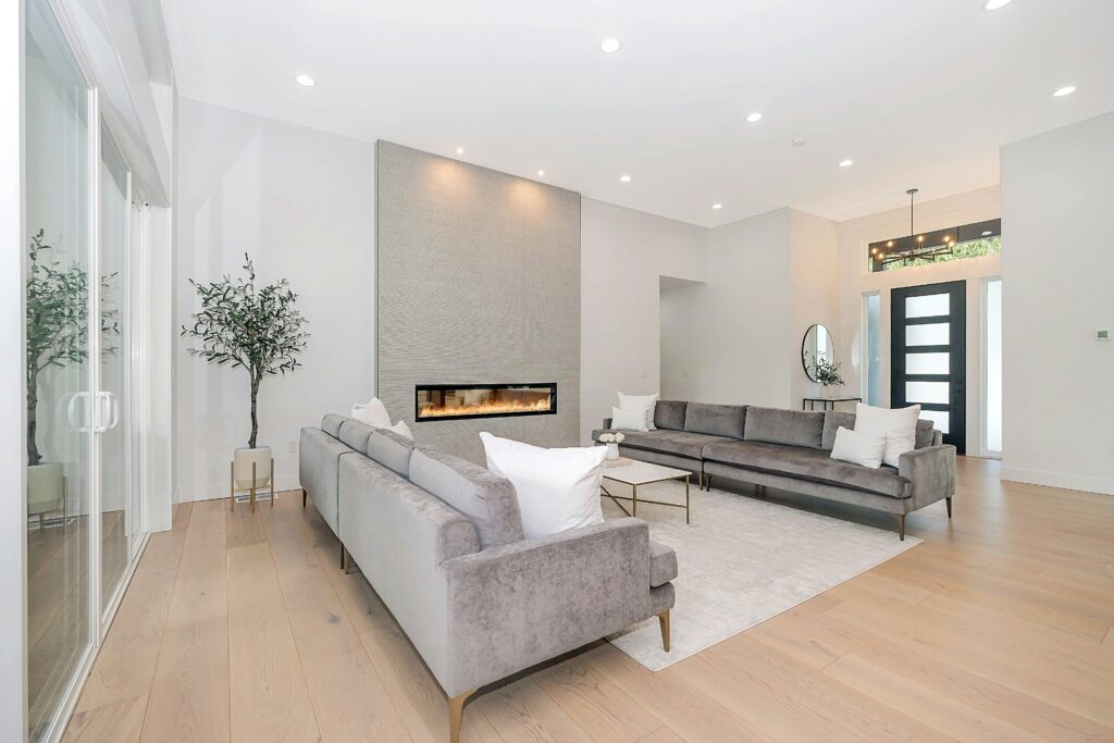 Modern open-concept living room with fireplace and contemporary finishes